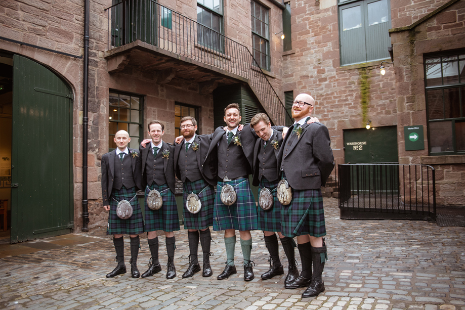 Groomsmen pose in Verdant Works Courtyard